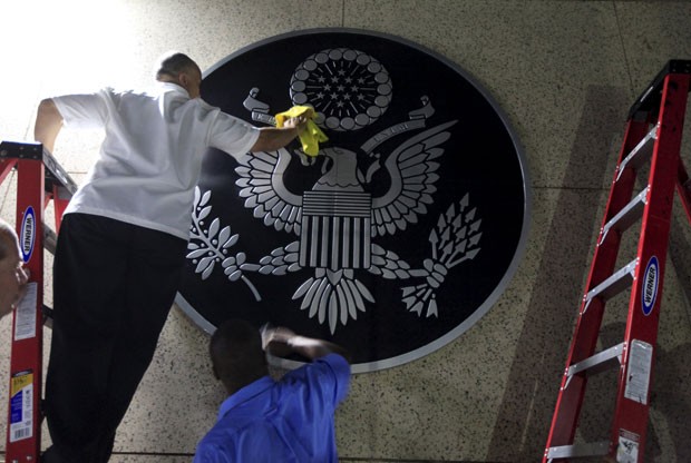Trabalhadores instalam escudo na porta da embaixada dos EUA em Havana (Foto: Enrique De La Osa)