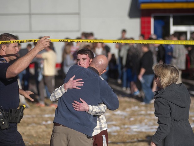 Pai abraça filho após o tiroteio em escola no Colorado. (Foto: Evan Semon/Reuters)