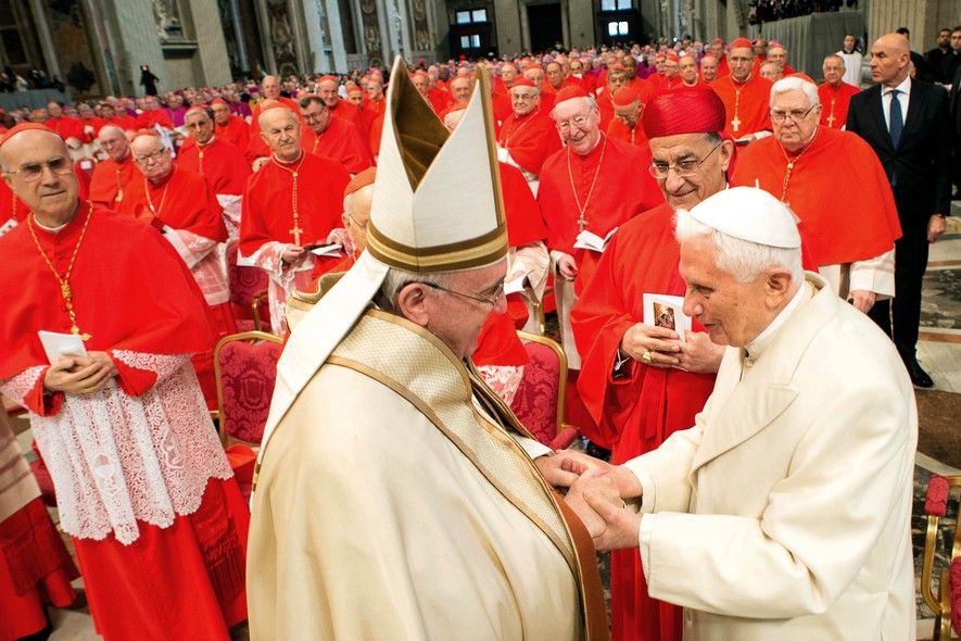 Pope Emeritus Benedict XVI, right, greets Pope Francis in St. Peter's Basilica at the Vatican, Saturday, Feb. 14, 2015. Pope Francis welcomed 20 new cardinals Saturday into the elite club of churchmen who will elect his successor and immediately delivered