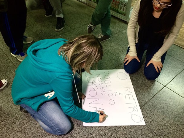 Mulher escreve cartaz em manifestação contra o abuso sexual no Metrô de São Paulo (Foto: Anne Barbosa/G1)