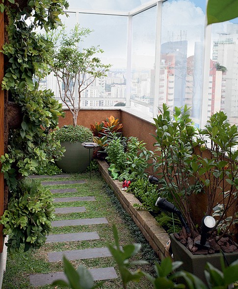 Para trazer o clima mineiro a esta cobertura, pedido da moradora, a paisagista Juliana Freitas usou o corredor para criar uma horta. O piso frio foi substituído por grama esmeralda com réguas de piso cimentício