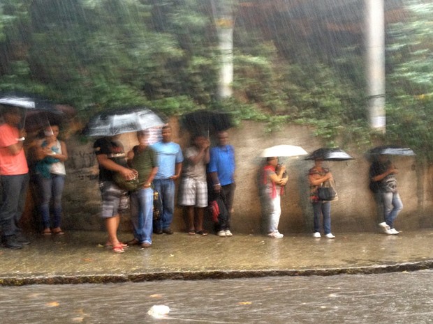 Passageiros esperam o ônibus debaixo de chuva forte em um ponto no Horto, Zona Sul da cidade (Foto: Bernardo Tabak/G1)