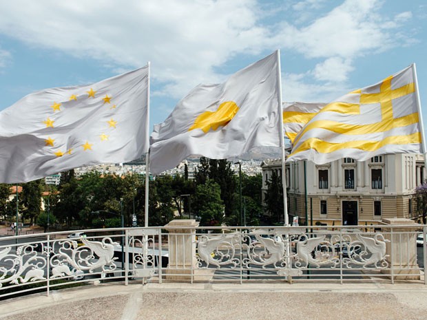 Obra 'Flags', de Ai Weiwei, que têm três bandeiras: União Europeia (à esquerda), silhueta de Alan Kurdi (ao centro), o menino sírio encontrado morto afogadado em praia grega, e da própria Grécia (à direita) (Foto: Divulgação)