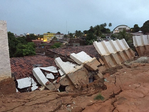 Muro caiu no bairro de Mandacaru e atingiu uma casa (Foto: Walter Paparazzo/G1)
