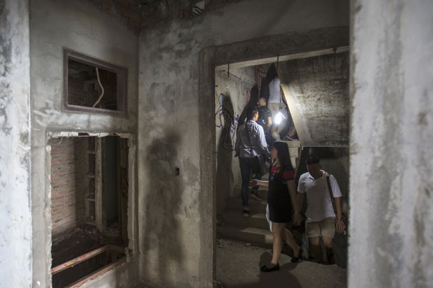 Visitantes dentro do prédio abandonado, conhecido como Torre Fantasma (Foto: Athit Perawongmetha/Reuters)