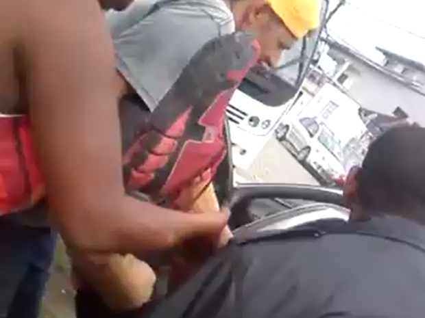 Moradores se juntaram para colocar rapaz dentro de carro em Guarujá (Foto: G1)