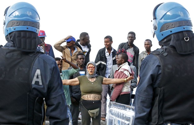 Grupo de imigrantes enfrenta a polícia durante remoção forçada na região de Saint Ludovic (Foto: Eric Gaillard/Reuters)