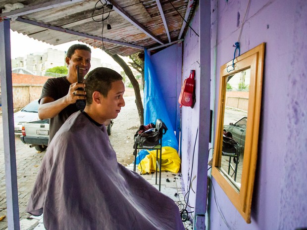 Há dois anos, William sempre procura o barbeiro ao ar livre para cortar o cabelo. (Foto: Jonathan Lins/G1)