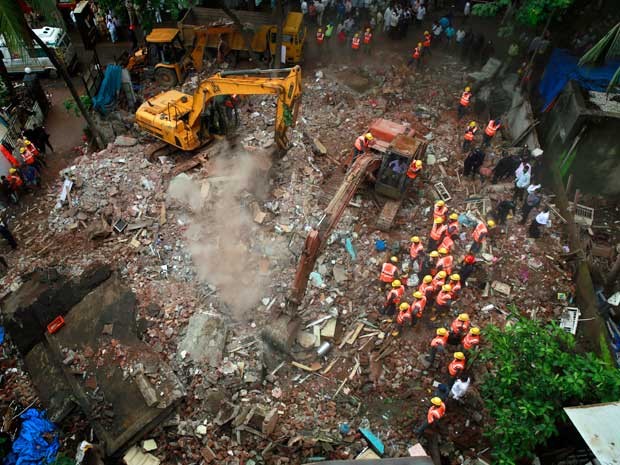 Máquinas são usadas para a retirada de destroços após prédio ruir na Índia (Foto: Rafiq Maqbool / AP Photo)