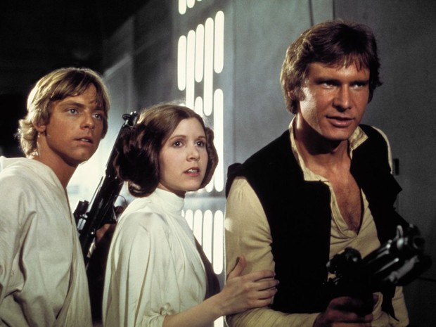 Mark Hammil, Carrie Fisher e Harrson Ford em 'Star Wars - Uma Nova Esperança' (1977). (Foto: Divulgação/Lucas Film) Mark Hammil, Carrie Fisher e Harrson Ford em 'Star Wars - Uma Nova Esperança' (1977). (Foto: Divulgação/Lucas Film)