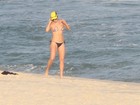 De biquíni, Christine Fernandes corre na praia