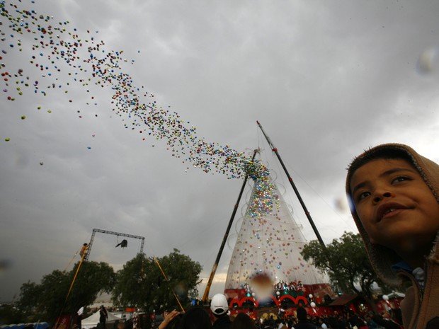 Menino observa os balões sendo lançados para o céu no bairro Iztapalapa. As pessoas costumam dar presentes neste 6 de janeiro, em vez  de trocar lembranças no Natal. (Foto: AP Photo/Marco Ugarte)