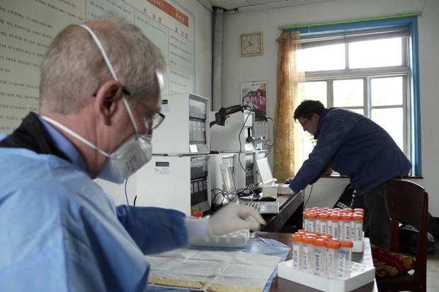  Foto mostra voluntários americanosanalisando testes de pacientes com tuberculose em um centro de tratamento de tuberculose na Coreia do Norte; o país tem uma epidemia de tuberculose resistente a drogas (Foto: AP Photo/Eugene Bell Foundation)