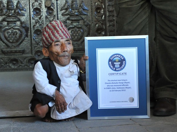 Em foto de 26 de fevereiro de 2012, Chandra Bahadur Dangi posa ao lado do certificado do Livro Guinness de Recordes (Foto: AFP Photo/Prakash Mathema)