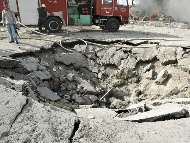 Uma explosão deixou enorme buraco. (Foto: Agência estatal Sana / Reuters)