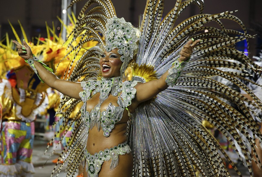 A dancer from the Academicos do Tucuruvi samba school performs during the Carnival parade at the Sambodromo in Sao Paulo, Brazil, Friday, Feb. 13, 2015. (AP Photo/Andre Penner)