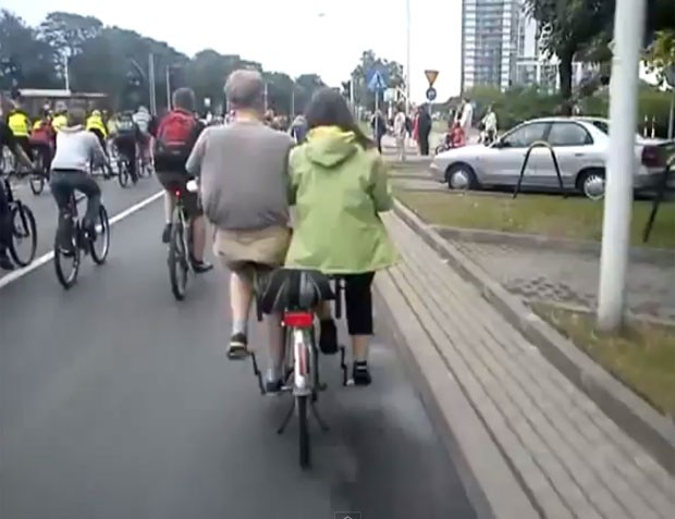 Vídeo mostra casal pedalando em uma bicicleta que conta com dois assentos lado a lado (Foto: Reprodução/YouTube/Marcin Zakrzeski)