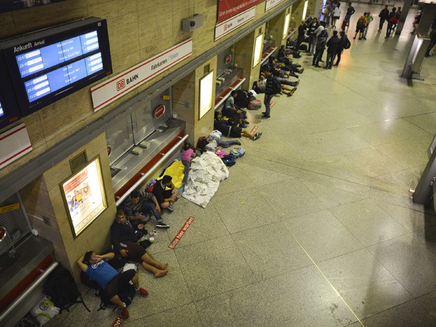 Refugiados dormem na estação central de Munique, no sábado (12) (Foto: AFP PHOTO/PHILIPP GUELLAND)