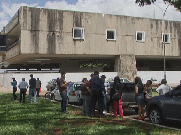 Funcionários ficam do lado de fora do prédio após ouvirem estalo (Foto: TV Globo/ Reprodução)