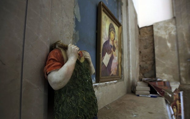 Imagem sacra ficou sem cabeça durante destruição (Foto: Joseph Eid/AFP) Imagem sacra ficou sem cabeça durante destruição (Foto: Joseph Eid/AFP)