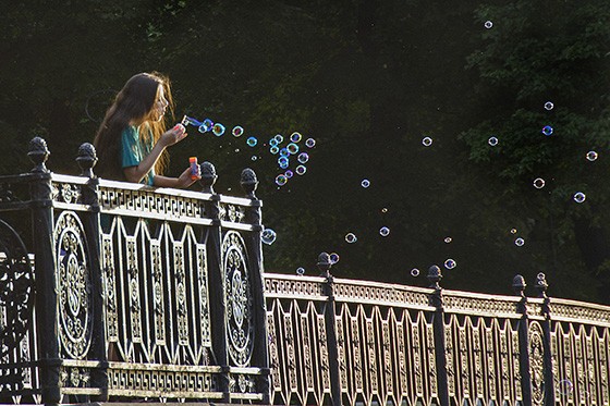 Uma jovem espalha bolhas de sabão em um jardim de São Petersburgo, às margens de um canal  (Foto: © Haroldo Castro/ÉPOCA)