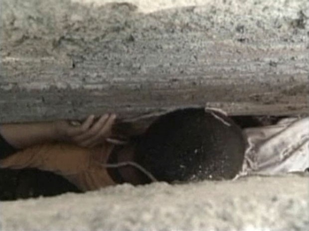 Criança ficou presa na fenda após cair enquanto brincava com amigos (Foto: CCTV/Reuters)