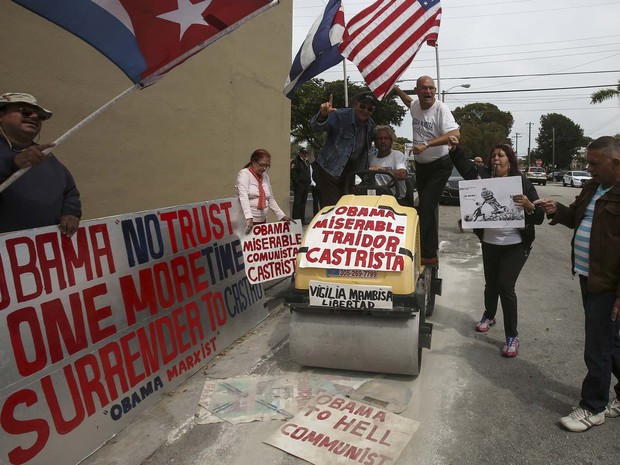 Em protesto nesta segunda-feira (21) em Miami, manifestantes exibem cartazes contra visita de Barack Obama a Cuba (Foto: REUTERS/Carlo Allegri)