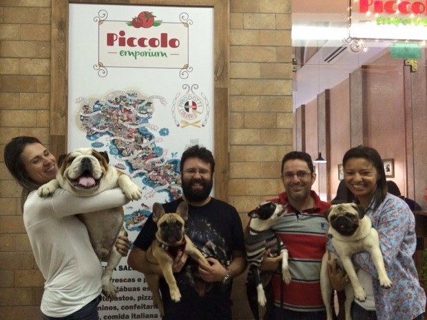 Donos posam com c&atilde;es na entrada de restaurante de Bras&iacute;lia que oferece petiscos e cerveja pr&oacute;pria para pets (Foto: Piccolo Emporium/Divulga&ccedil;&atilde;o)