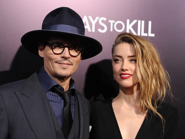Johnny Depp e Amber Heard em pré-estreia de filme em Los Angeles, nos Estados Unidos (Foto: Robyn Beck/ AFP)