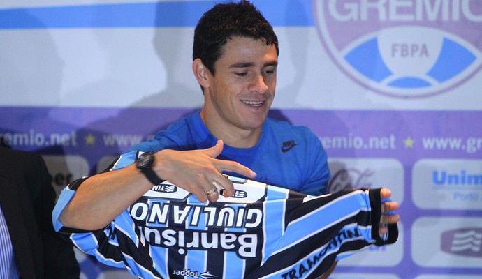 Giuliano veste a camisa do Grêmio na apresentação (Foto: Lucas Uebel/Grêmio)