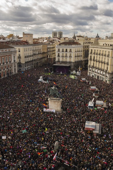 Podemos leader Pablo Iglesias speaks from the stage, as people gather in the main square of Madrid during a Podemos (We Can) party march in Madrid, Spain, Saturday, Jan. 31, 2015. Tens of thousands of people, possibly more, are marching through Madrid