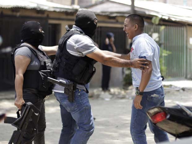 Homem se enfurece em cena de crime, onde cinco pessoas foram mortas a tiros por homens armados ( (Foto: Jorge Cabrera/Reuters)