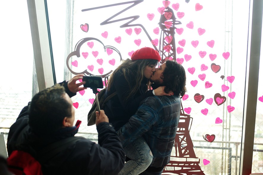 A couple kiss on the first floor of the Eiffel Tower, during Valentine's day, in Paris, Saturday, Feb. 14, 2015. Valentine's Day is observed on February 14 each year as a special day to celebrate love and romance. (AP Photo/Thibault Camus)