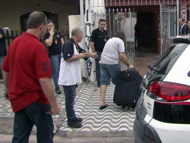 Suspeito de matar zelador entra na casa com a mala (Foto: Reprodução/TV Tribuna)