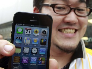 Taiyo Nakashima exibe seu iPhone 5, comprado em uma Apple Store em Tóquio, no Japão, nesta sexta-feira (21). O primeiro comprador ficou 5 dias na fila à espera da chegada do novo smartphone. (Foto: Yuriko Nakao/Reuters)