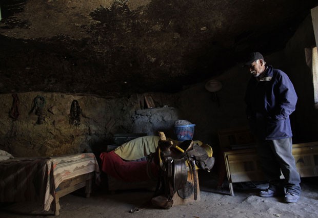 Benito mostra o interior de seu lar, onde parte das paredes e o teto são a própria rocha escavada (Foto: Daniel Becerril/Reuters)