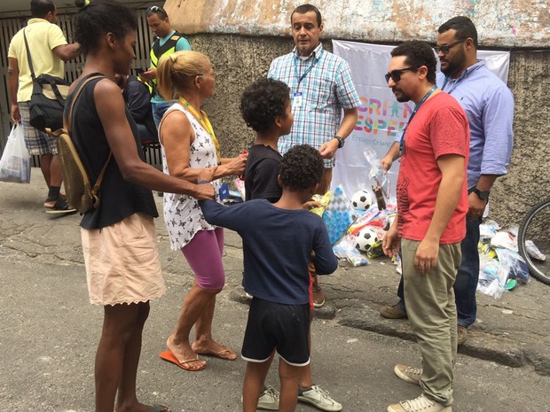 Integrantes da ONG Viva Rio fazem distribuição de brinquedos em acesso da comunidade Pavão Pavãozinho (Foto: Foto:Miguel Azevedo)