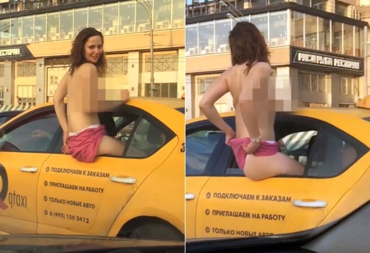 Mulher seminua se arrisca ao se exibir para motoristas em Moscou