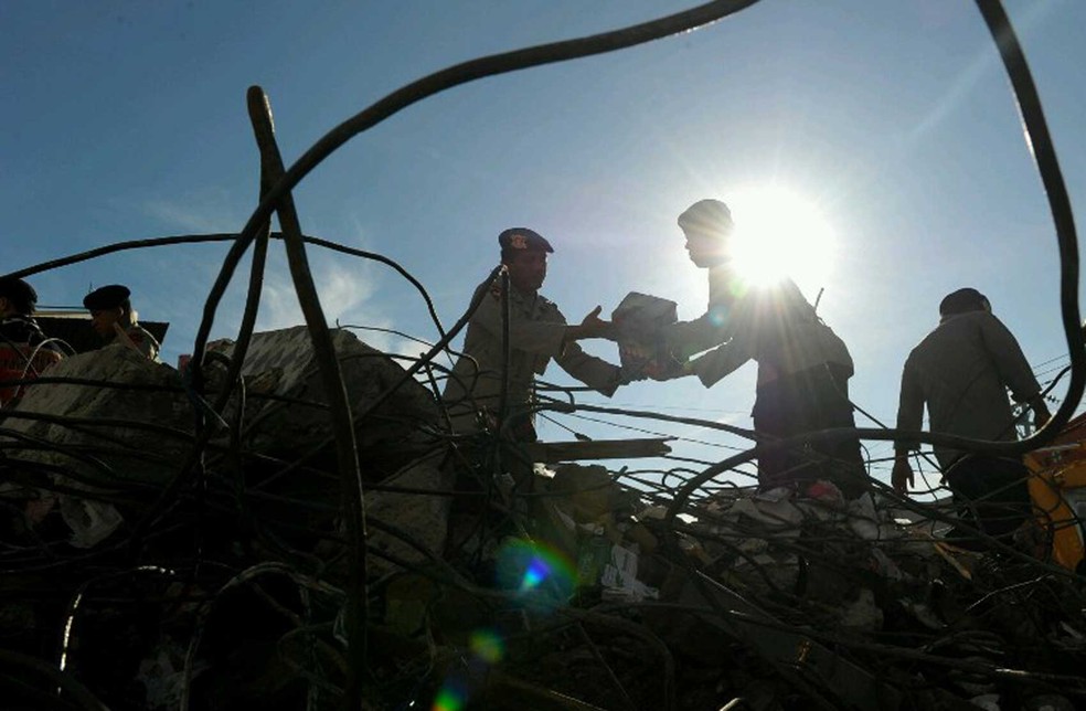 Equipes de resgate trabalham nos escombros do terremoto na Indonésia  (Foto: Chaideer Mahyuddin / AFP)