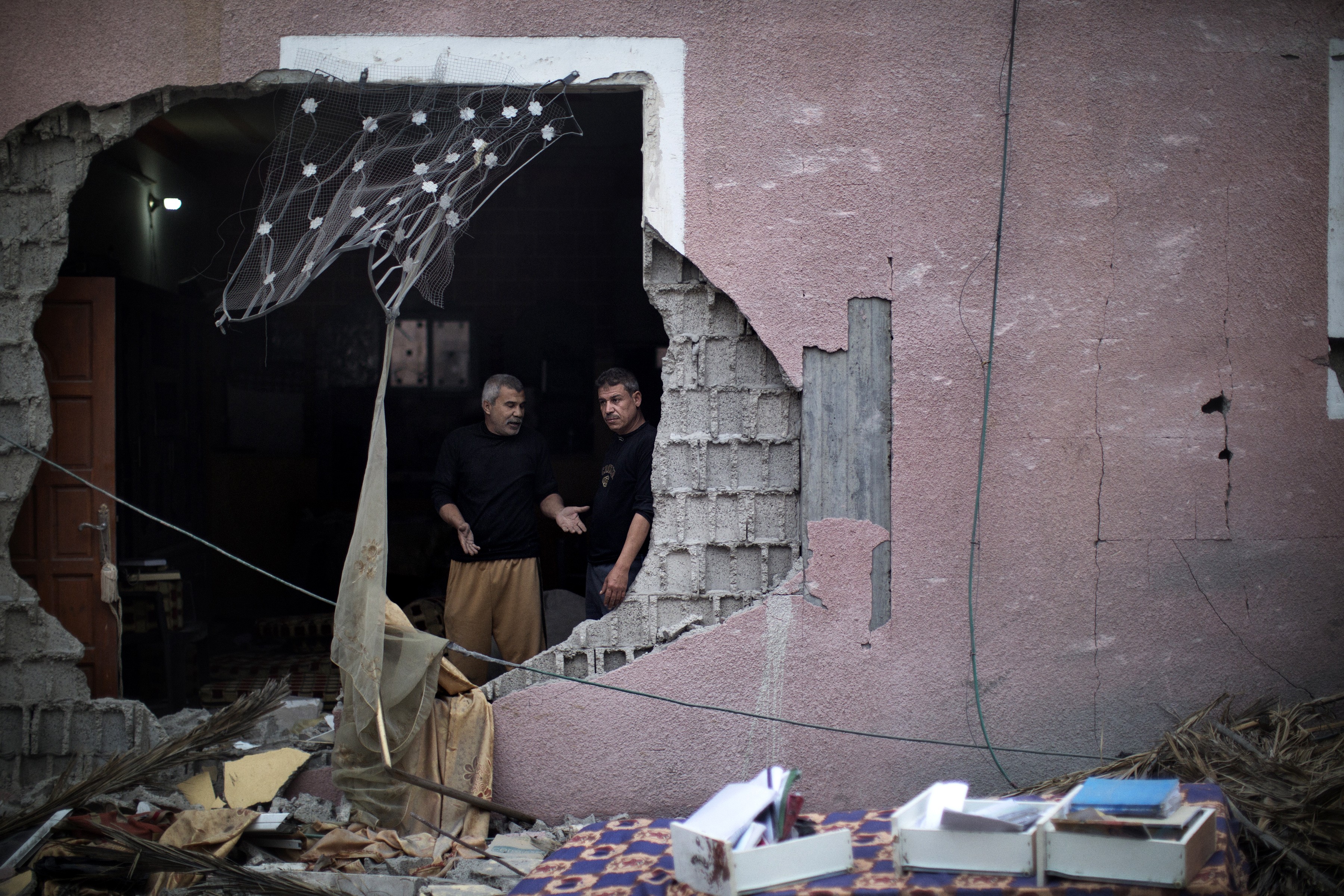 Palestinos observam estragos após ataque aéreo israelense na Cidade de Gaza em 17 de novembro de 2012. Os ataques atingiram a sede do gabinete de governo do Hamas em Gaza, depois que militantes dispararam foguetes contra Jerusalém e Tel Aviv (Foto: MARCO LONGARI / AFP)