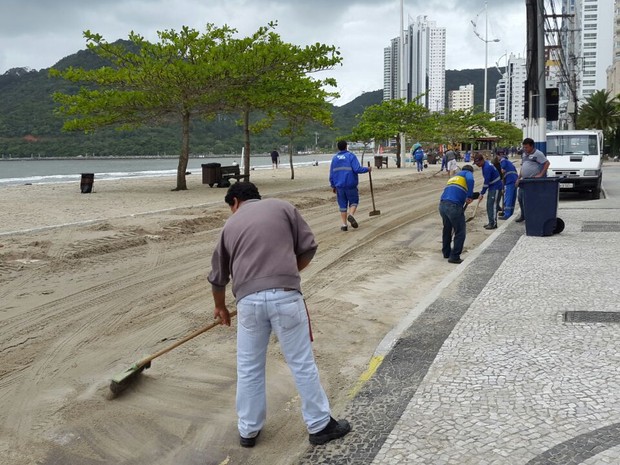 Operários removeram areia da Avenida Atlântica (Foto: Luiz Souza/RBS TV)
