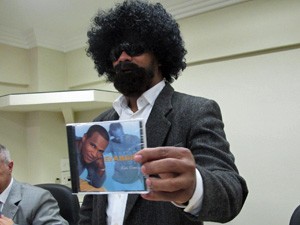 Evandro exibe capa de CD na qual aparece sem disfarce (Foto: Marcelo Mora/G1)