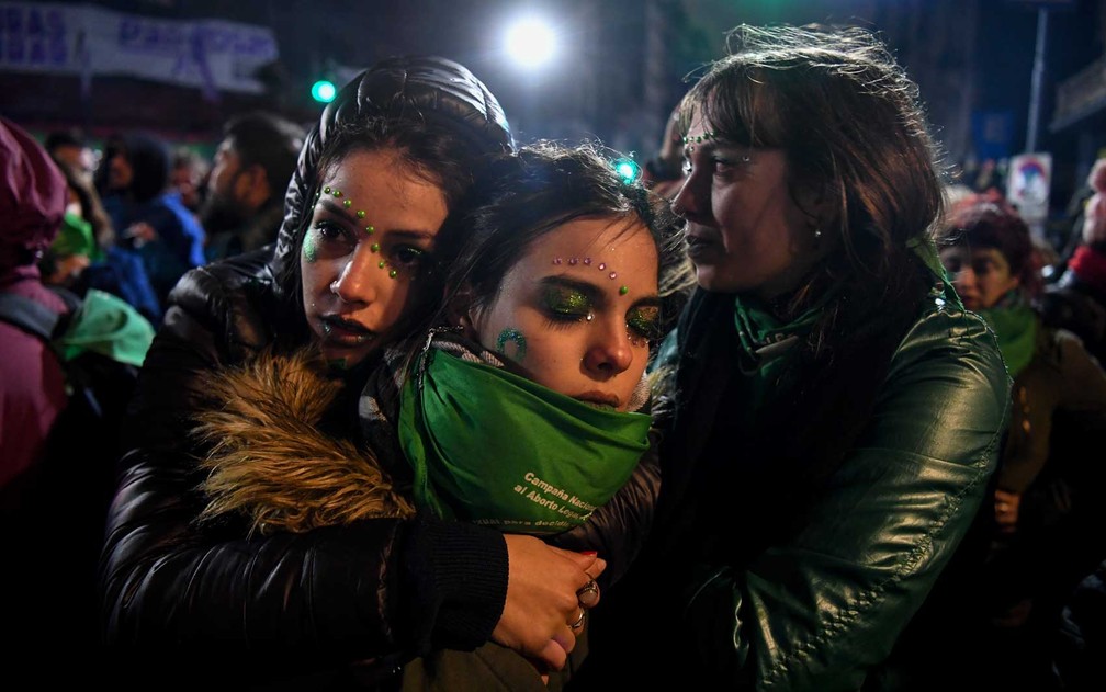Ativistas a favor da legalização do aborto se consolam em Buenos Aires (Foto: Eitan Abramovich / AFP)