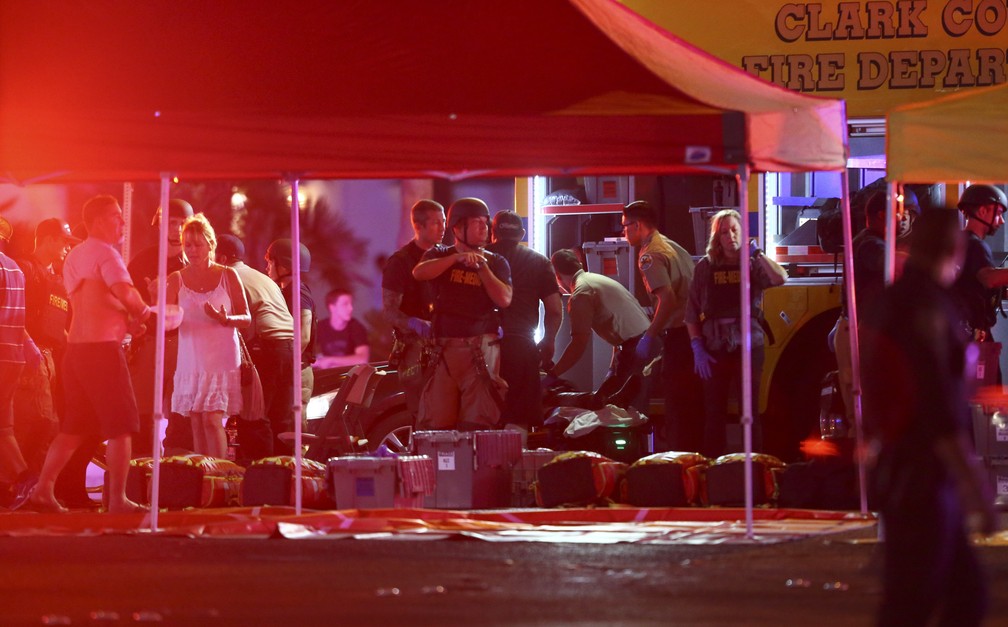 Médicos tratam feridos enquanto polícia de Las Vegas busca por suspeitos após centenas de tiros serem disparados em frente a resort e casino de Las Vegas (Foto: Chase Stevens/Las Vegas Review-Journal via AP)