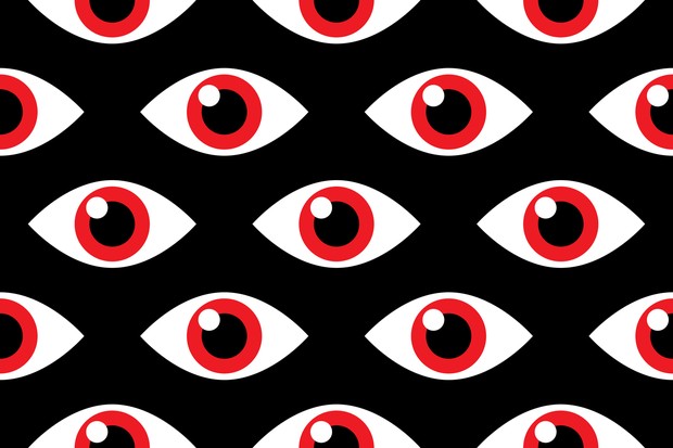 Vector illustration of red eyes in a repeating pattern against a black background. (Foto: Getty Images)