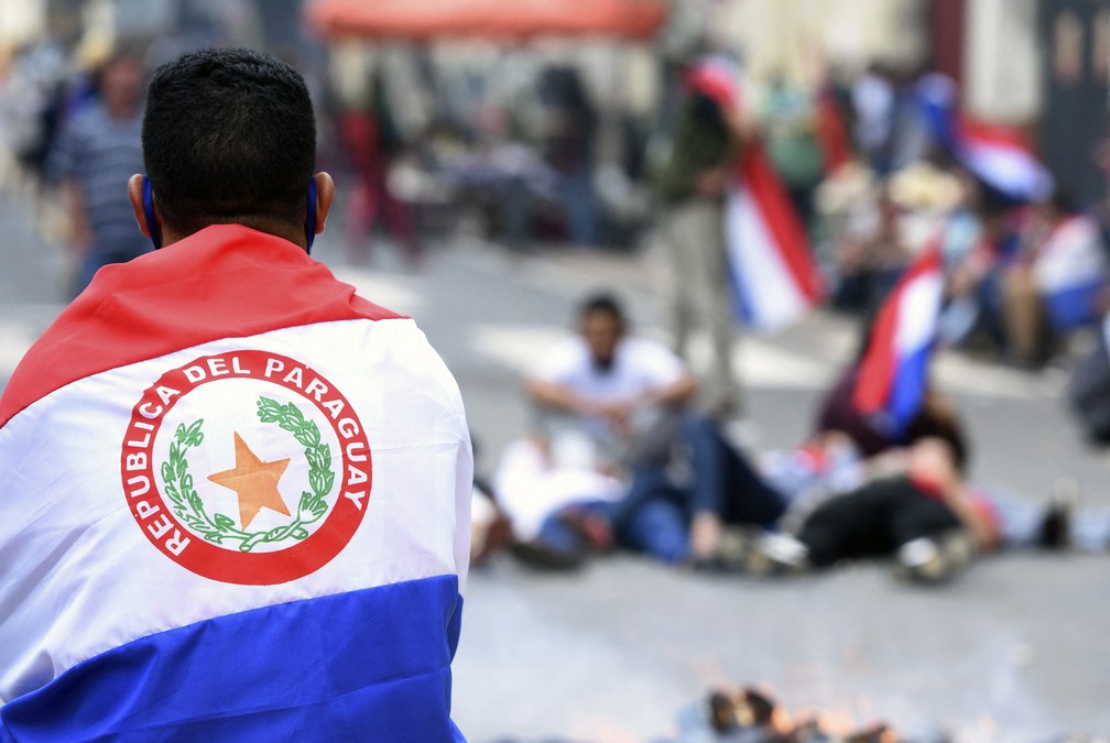 Manifestantes usam bandeiras do Paraguai em atos contra o presidente Mario Abdo nesta quarta-feira (17) — Foto: Daniel Duarte/AFP