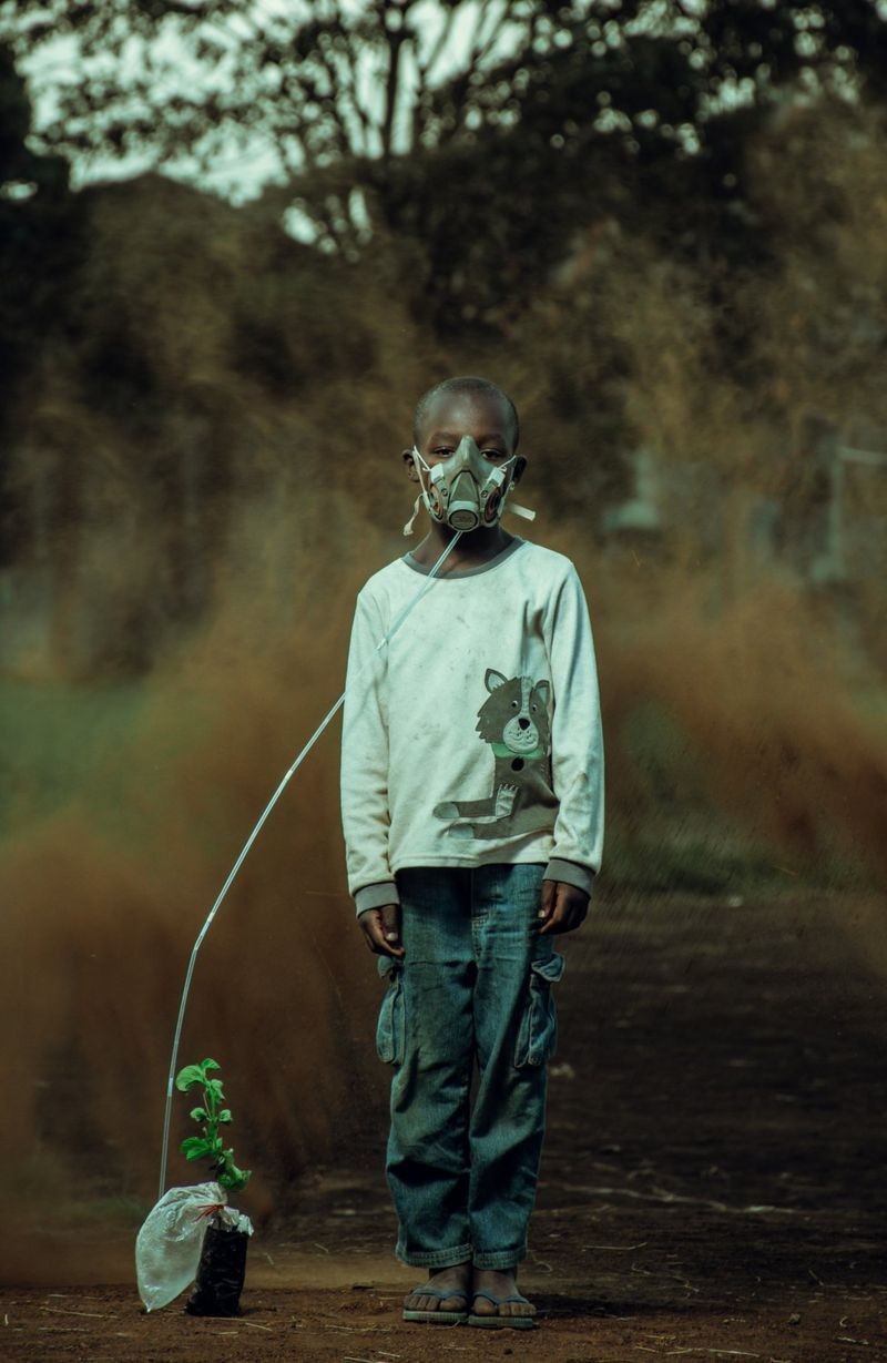 "Um menino respira o ar de uma planta, com uma tempestade de areia se formando ao fundo, em uma representação artística das mudanças que virão." (Foto: KEVIN OCHIENG ONYANGO / Via BBC)
