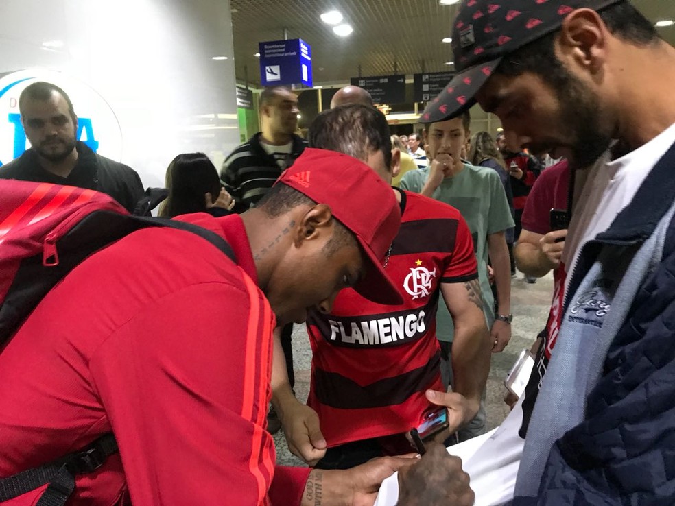 Vitinho assina a camisa de um torcedor no desembarque do Flamengo em Porto Alegre (Foto: Amanda Kestelman/GloboEsporte.com)