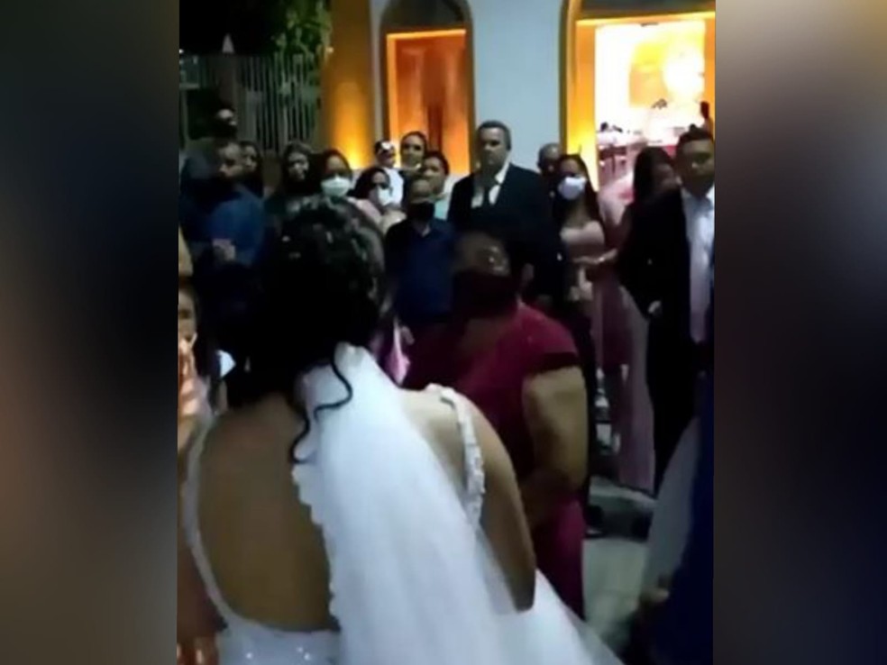 Noivos reuniram os convidados na frente da igreja para informar sobre o cancelamento da festa de casamento. — Foto: Reprodução