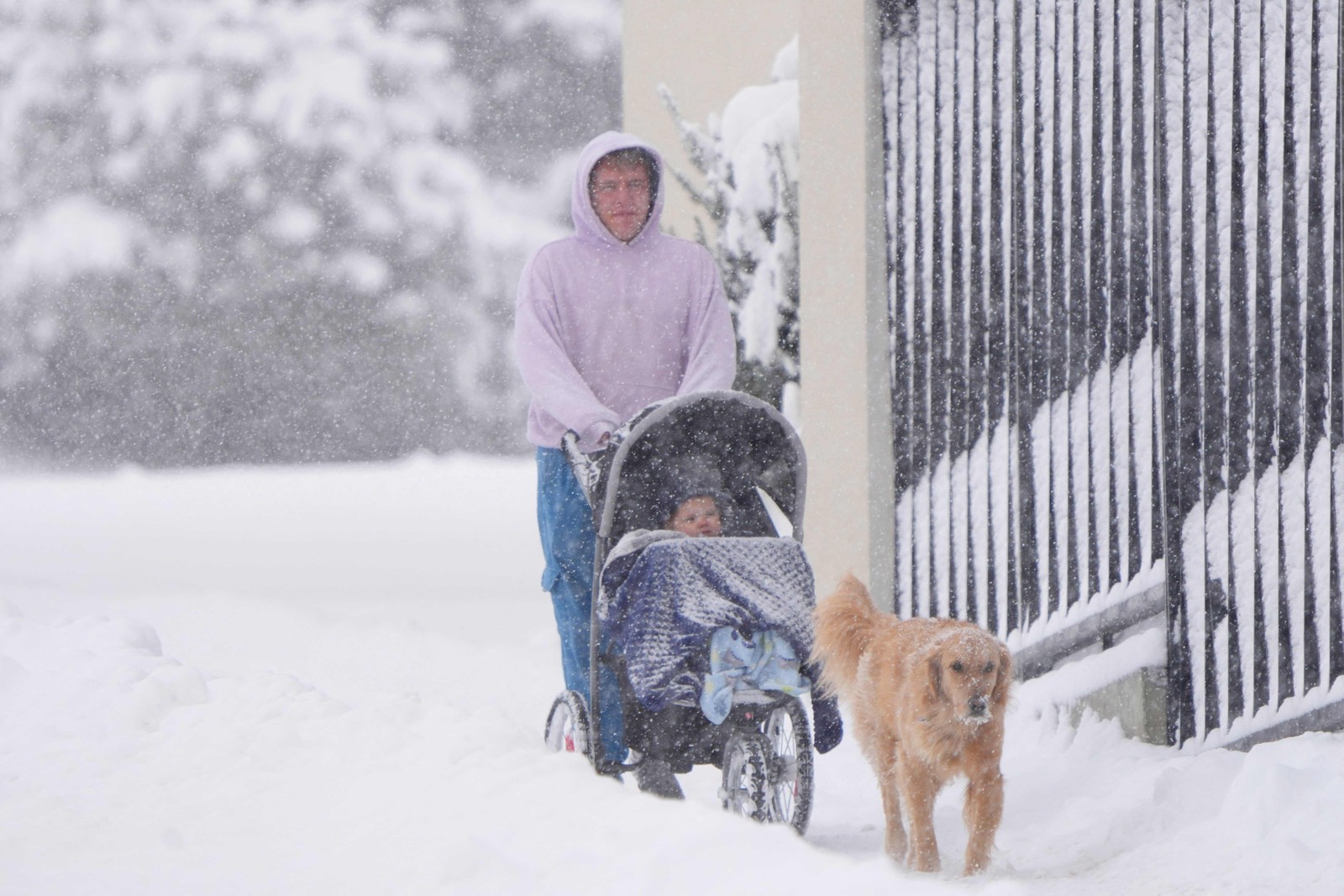 Pessoa caminha com seu cachorro durante uma tempestade de neve em Provo, Utah, EUA — Foto: GEORGE FREY/AFP